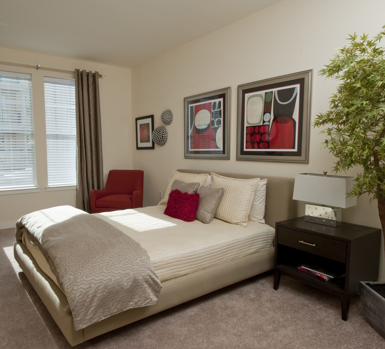 A fully-furnished bedroom with a large window