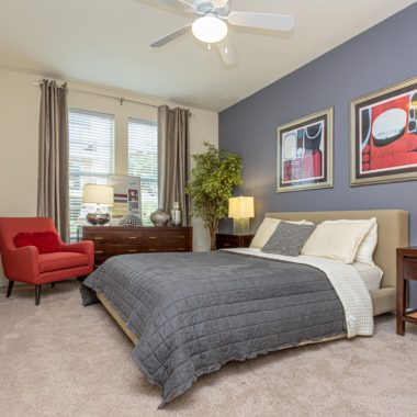 Large bedroom with a ceiling fan