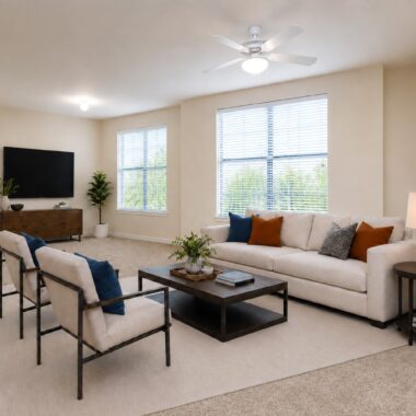 large living room with large windows and carpet and contemporary furniture with neutrals, blues, and oranges matching artwork