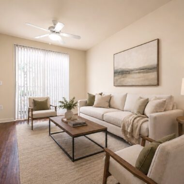 living room with balcony sliding door bringing in lots of natural light, with wood floors, and modern furniture in neutral and green accents