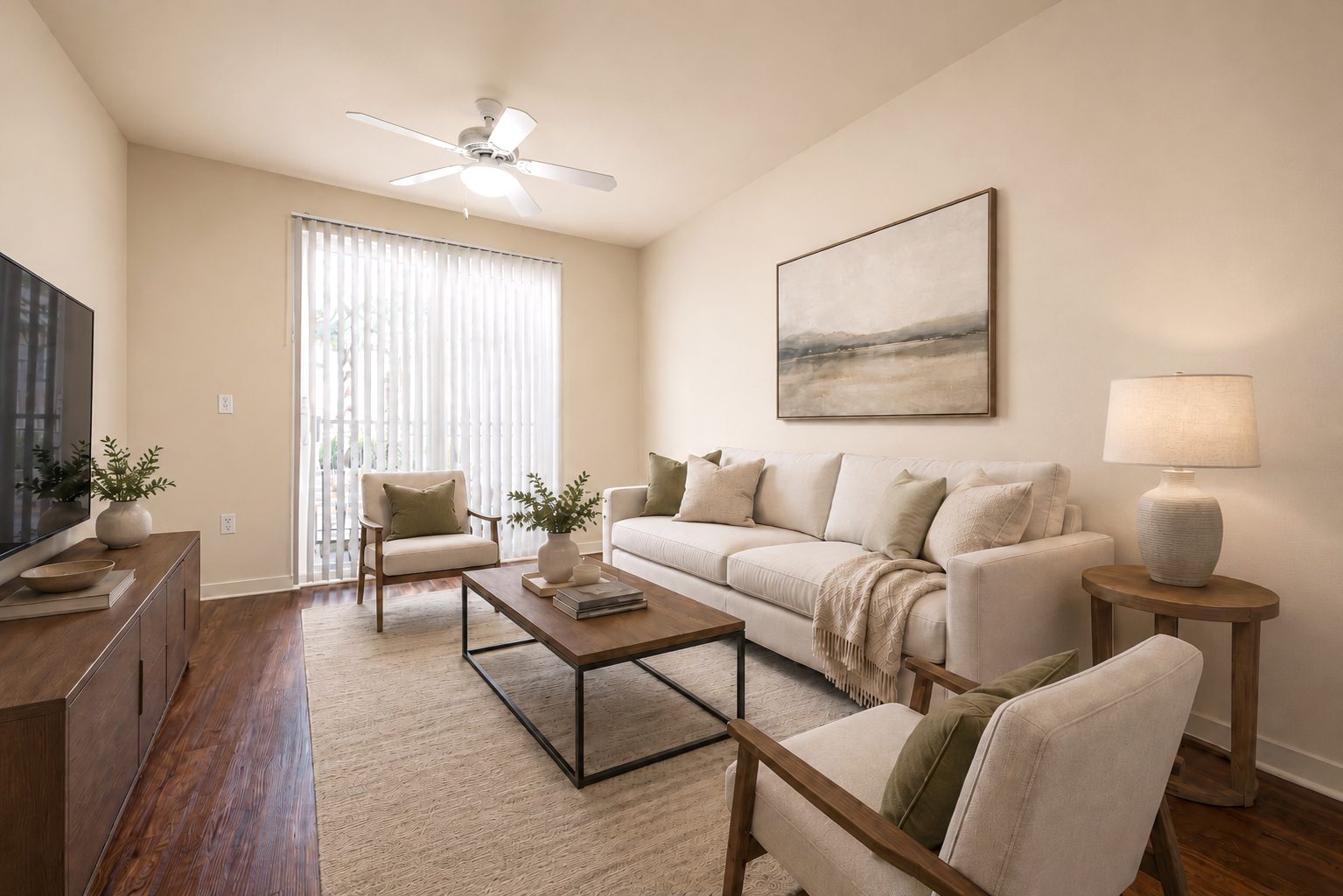 living room with balcony sliding door bringing in lots of natural light, with wood floors, and modern furniture in neutral and green accents